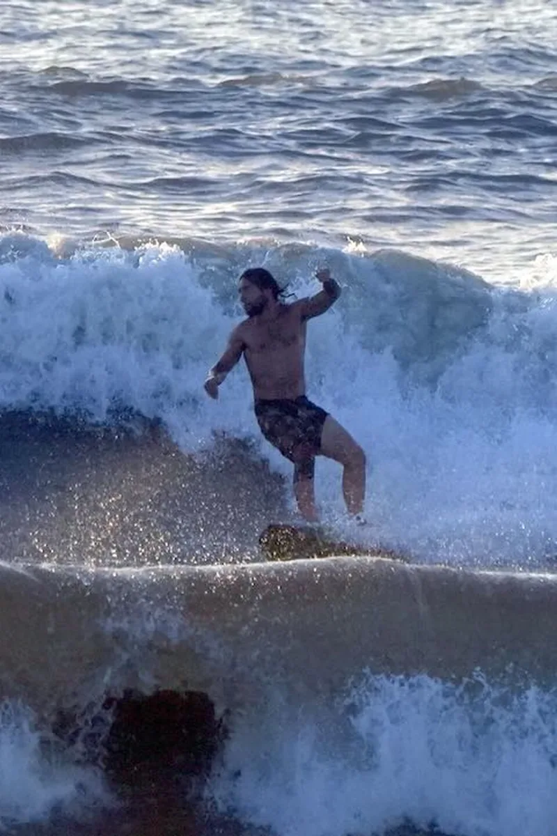 Luis riding a wave