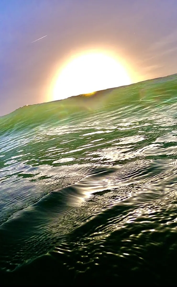Inside a wave at sunset